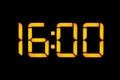 An electronic digital clock with yellow numbers on a black background shows the time. Sixteen zero zero o`clock of the day. Close