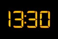 Electronic digital clock with yellow numbers on a black background shows the time Thirteen thirty hours of the day. Isolate, close Royalty Free Stock Photo