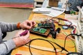 Electronic engineer works with a soldering iron. Work tools and equipment