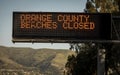 Electronic freeway sign in southern California stating Orange County Beaches Closed