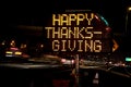 An electronic freeway sign stating Happy Thanksgiving with traffic