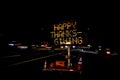 An electronic freeway sign stating Happy Thanksgiving with traffic