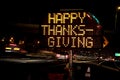 An electronic freeway sign stating Happy Thanksgiving with traffic Royalty Free Stock Photo