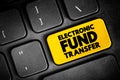 Electronic Funds Transfer is the electronic transfer of money from one bank account to another, text button on keyboard, concept Royalty Free Stock Photo