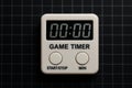 Electronic game timer with digital display and buttons for start and stop, placed on black gridded background, AI Generative Royalty Free Stock Photo