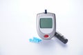 Electronic glucometer, lancet and test strip for determining blood sugar levels isolated on a white background. Diabetes