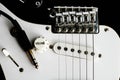 Electronic guitar details close up and wire cable jack. Close up black and white electronic guitar. Royalty Free Stock Photo