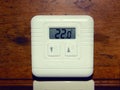 Electronic heating temperature controller, mounted on the wall of a wooden house Royalty Free Stock Photo