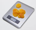 Electronic kitchen scale with dried apricots Royalty Free Stock Photo