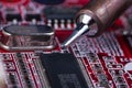 Electronic lab working place with soldering iron and circuit board Royalty Free Stock Photo