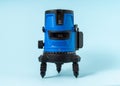Electronic laser level on light blue background Royalty Free Stock Photo