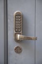 Electronic lock with numeric buttons for entering code and a handle for opening the door