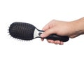 Electronic massage black comb in hand Royalty Free Stock Photo