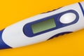 Electronic medical thermometer with blank screen on yellow background Royalty Free Stock Photo