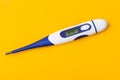 Electronic medical thermometer 37.5 degrees on yellow background Royalty Free Stock Photo