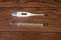 Electronic and mercury thermometers for measuring temperature.