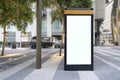 Electronic modern empty scoreboard on the background of a city street. Blank mock up of vertical street poster billboard on city