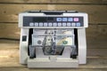 Electronic money counter machine is counting is counting the American hundred-dollar US dollars banknotes Royalty Free Stock Photo