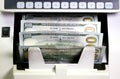 Electronic money counter machine is counting is counting the American hundred-dollar US dollars banknotes