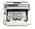 Electronic money counter machine is counting is counting the American hundred-dollar US dollars banknotes