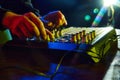 Electronic music, party and night club entertainment. Close-up of dj mixer, man adjusting sounds and beats on dark Royalty Free Stock Photo