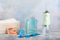 Electronic oral irrigator, toothbrush, paste, dental floss and mouthwash on background.