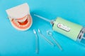 Electronic oral irrigator, toothbrush, paste, dental floss and mouthwash on background.