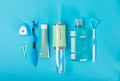 Electronic oral irrigator, toothbrush, paste, dental floss and mouthwash on background.