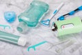 Electronic oral irrigator, toothbrush, paste, dental floss and mouthwash on background.