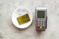 Electronic payments in restaurant. Bank card near aquiring terminal and bill on grey background top view Royalty Free Stock Photo