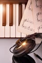 Electronic piano keyboard with headphones and sheet music top Royalty Free Stock Photo