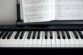 electronic piano keys and music sheets, black and white colors Royalty Free Stock Photo