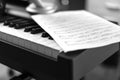 Electronic piano and musical sheet . Black and white photo, Musical Background