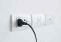 Electronic power plug plugged in a wall socket Royalty Free Stock Photo
