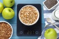 Electronic scales with granola and different products on light blue wooden table, flat lay Royalty Free Stock Photo