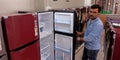 electronic shopkeeper showing refrigerator at showroom Royalty Free Stock Photo