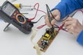 Electronic technician checks the fuse of the power supply