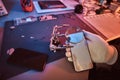 Electronic technician holds a modern smartphone with a broken body, carefully examines the damage using a magnifying