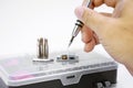 Electronic technician removing metal nut with a multi precision screwdriver Royalty Free Stock Photo