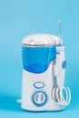 Electronic Tooth Irrigator for personal home usage on blue background Royalty Free Stock Photo