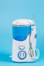 Electronic Tooth Irrigator for personal home usage on blue background