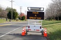 Electronic traffic control sign by the side of a road that says, \