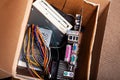 Electronic waste, cardboard box package full of e-waste, old dated desktop pc, computer components. Outdated technology