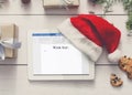 Electronic Wish List. Digital Tablet With Santa Hat, Creative Christmas Background Royalty Free Stock Photo