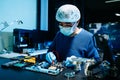 Electronics engineer repairing circuit board in laboratory. Technology, hardware repair, engineering, innovation, diagnostics, and Royalty Free Stock Photo