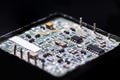 Electronics Industry and Manufacturing. Macro Shoot of Dusty Printed Circuit Board in Package with Surface Mounted Components Royalty Free Stock Photo