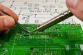 Electronics manufacturing services, manual soldering of electronic board Royalty Free Stock Photo
