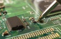 Electronics manufacturing services, soldering of electronic board Royalty Free Stock Photo