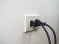 Electronics plugged in to the socket on white wall Royalty Free Stock Photo