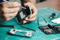 Electronics repair service. Technician disassembling smartphone for inspecting